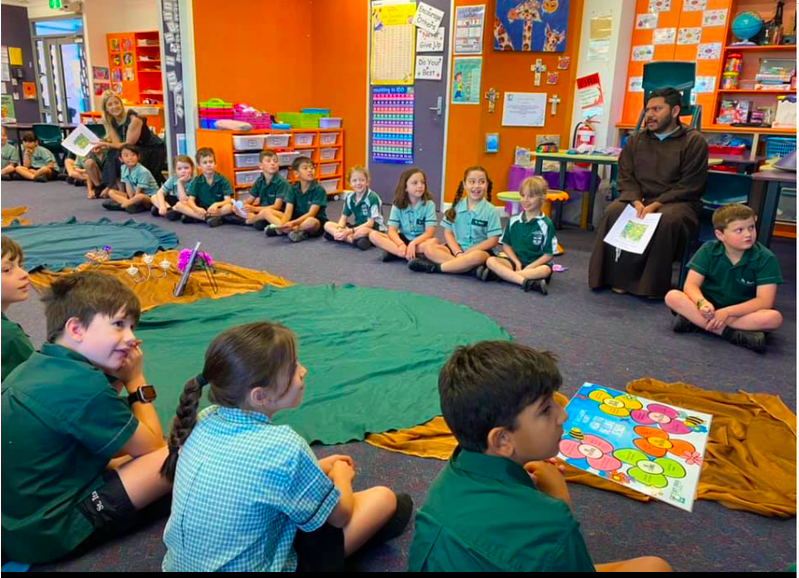Students sitting together in a classroom circle with staff, highlighting shared learning, listening and respectful classroom community